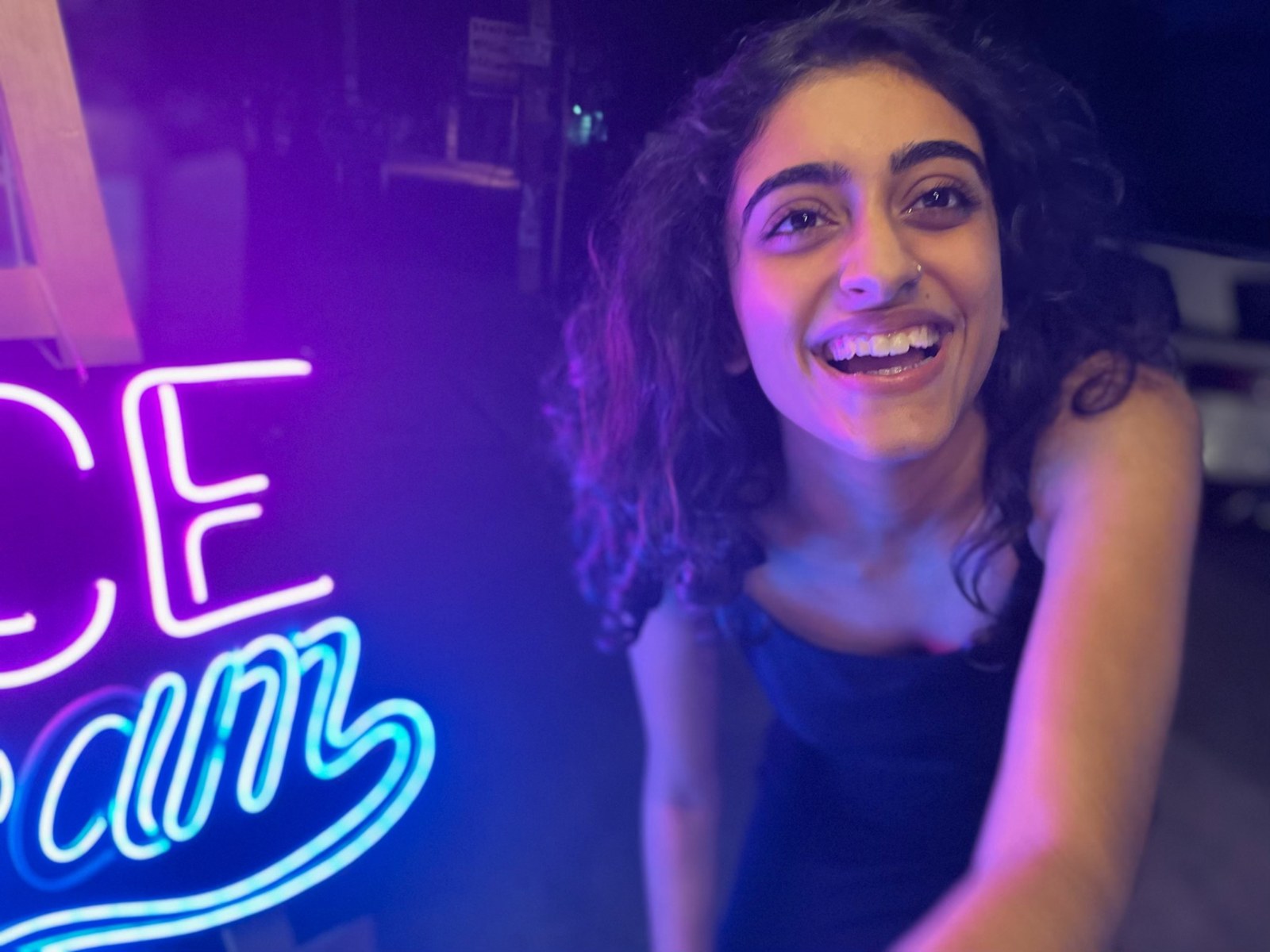 Vanshika laughing under neon lights